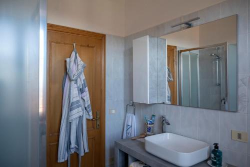 a bathroom with a sink and a mirror at Sonia House Discover Tuscany in Torniella