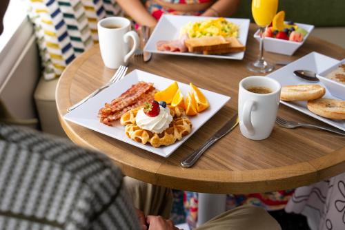 a table with a plate of breakfast food on it at Hyatt Place Bayamon in Bayamón