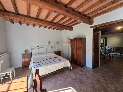 a bedroom with a bed and a wooden ceiling at Casale Montone , villa with private pool in Montone