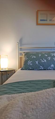 a bedroom with a bed with a blue and white pillow at Lemon Tree Apartment with Garden in Chios