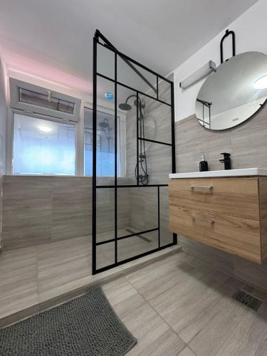 a bathroom with a glass shower and a sink at Born by the sea in Vama Veche