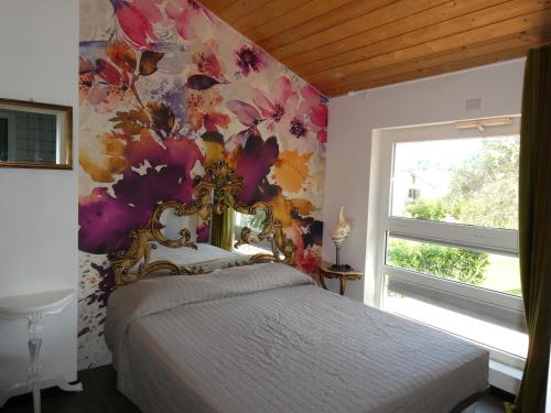 a bedroom with a bed with a floral wall at VILLA DELLE ROSE CINQUE TERRE in Beverino