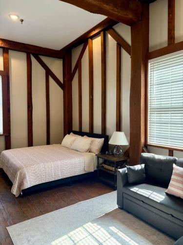 a bedroom with a bed and a couch in a room at Riverbend Suite - Potter’s Mill in Bellevue