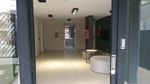 a hallway of a building with a room with a table at Dpto tte ibañez in Cipolletti