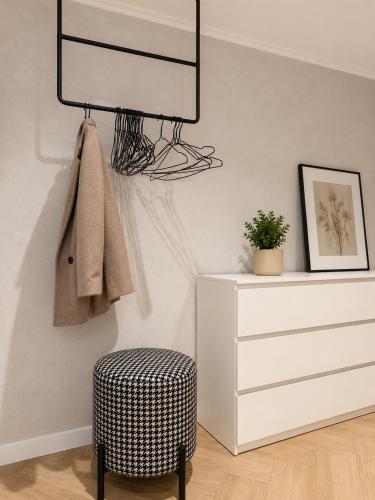 a room with a ottoman and a dresser at ZWIN Apartment 4 in Skole