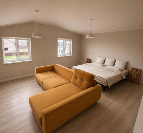 a living room with a bed and a couch at ZWIN Apartment 4 in Skole