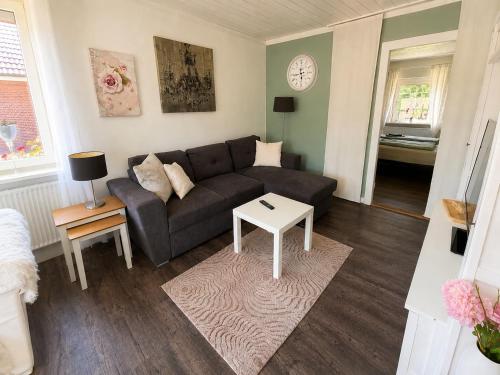 a living room with a couch and a table at Lütte Butze in Marne