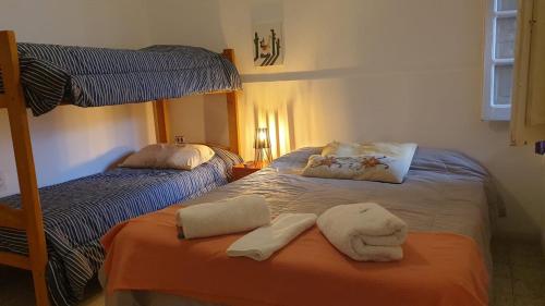 a bedroom with two bunk beds with towels at LosCardones in Cafayate