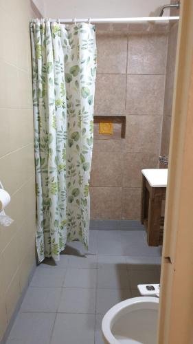 a bathroom with a shower curtain and a sink at LosCardones in Cafayate
