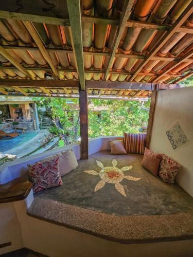 a room with a bed with a painting on it at Canto Verde Pousada in Lençóis