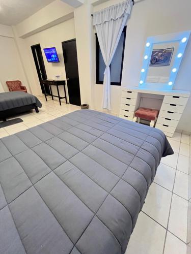 a bedroom with a large bed in a room at HOTEL BOUTIQUE ÁRBOL De LA VIDA in Taxco de Alarcón
