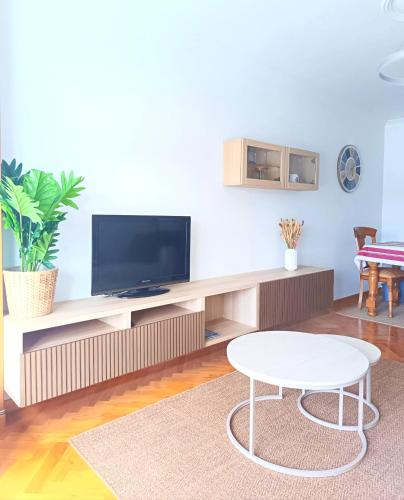 a living room with a tv and a table at Viveiro Centro con Vistas in Viveiro