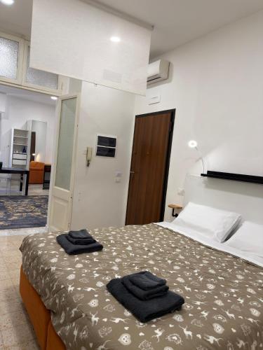 a bedroom with a bed with two towels on it at La Casa di Peppe in Rieti