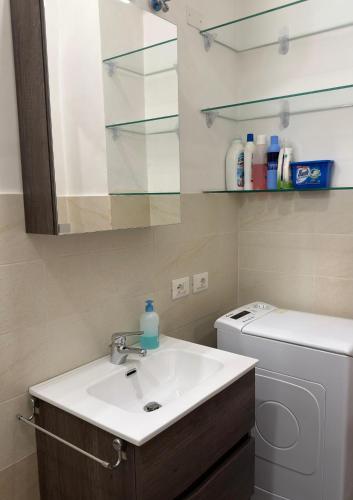 a bathroom with a sink and a washing machine at La Casa di Peppe in Rieti
