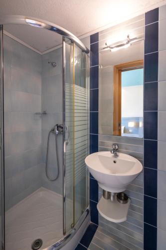 a bathroom with a sink and a shower at Cristels Studios 1 in Skala Marion