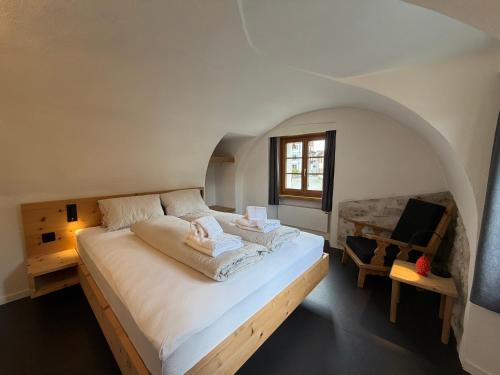a bedroom with a large bed in an attic at Pensiunina - Pension - Sent in Sent