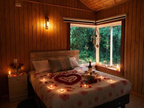 a bedroom with a bed with lights on it at El Urco Chiloé - Cabaña La Fiura in Ancud