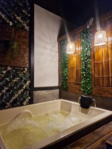 a bath tub filled with water in a room at Tacuara House in San Gil