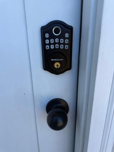 a door with a black button on a white door at Willow Pond Cabin in Ellensburg