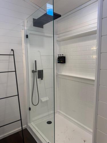 a shower with a glass door in a bathroom at Willow Pond Cabin in Ellensburg