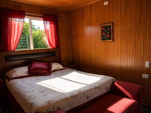 a small bedroom with a bed and a window at El Urco Chiloé - Hostal y Cabaña in Ancud