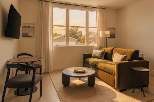 a living room with a couch and a table at Ceros in Denver