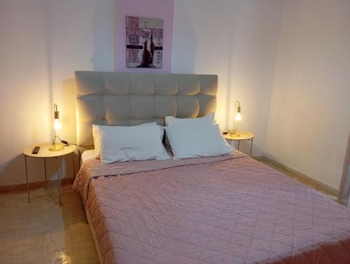 a bedroom with a large bed with two side tables at Nadia Studios in Kalamaki