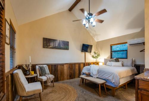 a bedroom with a bed and a table and chairs at Nicole Creek Cabins in Waco