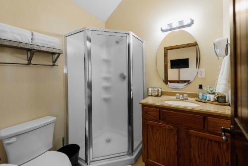 a bathroom with a shower and a sink at Nicole Creek Cabins in Waco