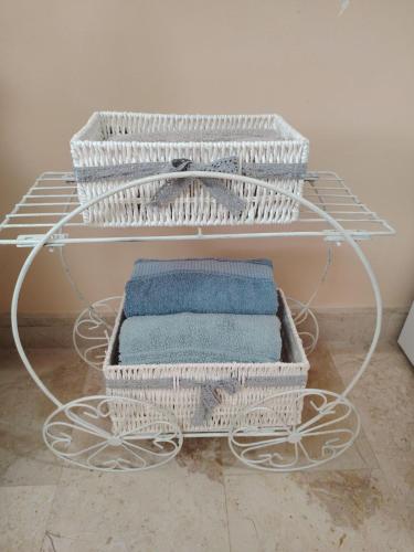 a white rack with two baskets of towels at Студио за гости БОРИСА in Kranevo