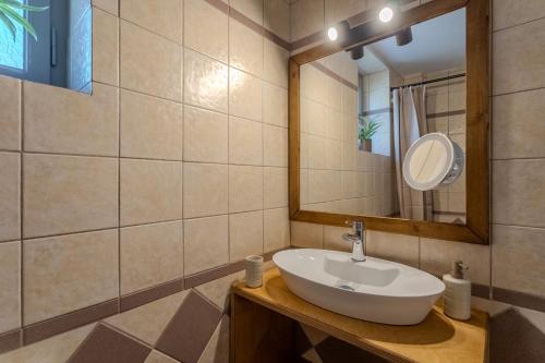 a bathroom with a sink and a mirror at Aether Blue Eco Villas in Agios Nikolaos