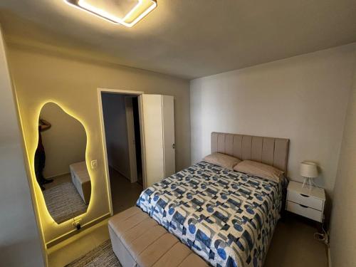 a small bedroom with a bed and a mirror at Lar de Noel in Rio de Janeiro