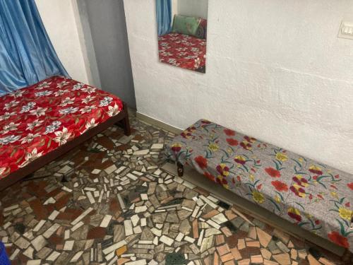 a room with two beds and a mirror at sree thilak apartments in Guruvāyūr
