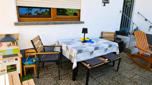 a table with chairs and a table cloth on it at Ferienwohnung Panoramablick Bermersbach in Forbach