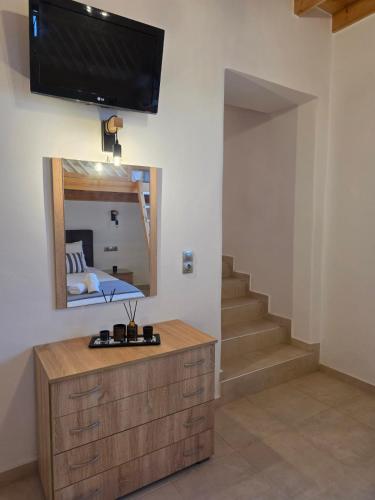a room with a mirror and a tv on the wall at Villa Natural View in Moutsoúna