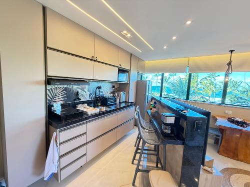 a kitchen with a sink and a counter top at Marulhos resort Muro Alto flats Premium frente ao mar in Porto De Galinhas