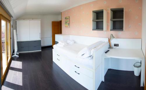 a room with white cabinets and a desk in it at Welcome Villa O Sidrón in Alba