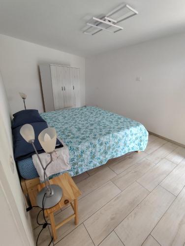 a bedroom with a bed and a table with a lamp at La Casina Procchio loc I Marmi in Procchio