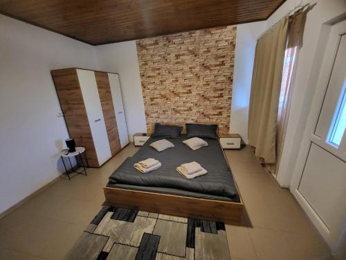 a bedroom with a bed with two pillows on it at Casa Claudiu in Eşelniţa
