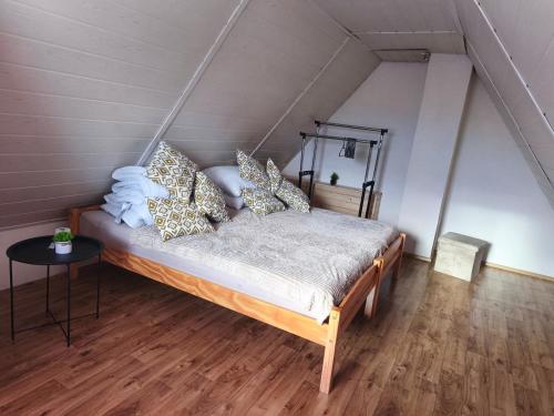 a bedroom with a bed with pillows on it at Chata Vrcov in Vrcov