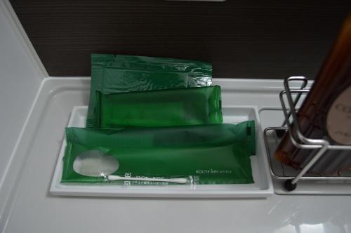 a white drawer with some green items in it at Hotel Route-Inn Yanagawa Ekimae in Yanagawa