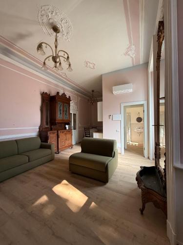 a living room with a couch and a chandelier at Zucca s home in Baveno