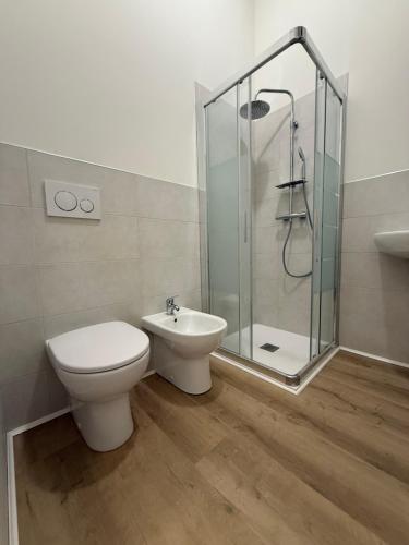 a bathroom with a toilet and a shower and a sink at Zucca s home in Baveno