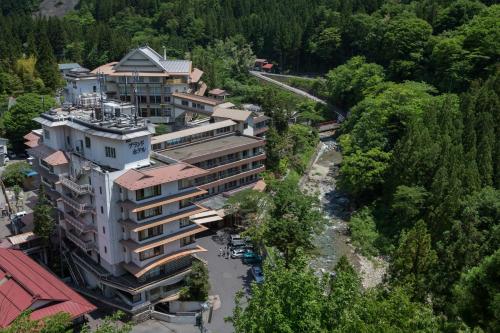 an aerial view of a building next to a river at Shima Grand Hotel in Nakanojo