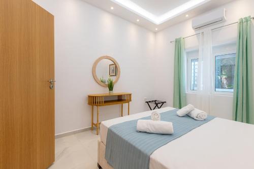 a bedroom with a bed with towels on it at Casa Lili in Platanias