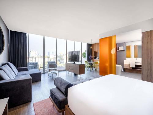 a hotel room with a bed and a living room at Mondrian Mexico City Condesa in Mexico City