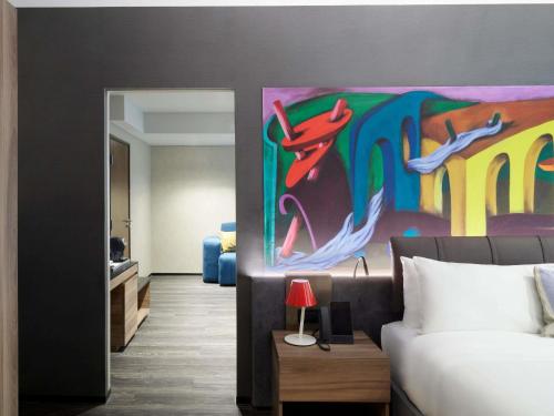 a room with a bed and a painting on the wall at Mondrian Mexico City Condesa in Mexico City