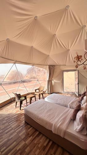 a bedroom with a bed and a large tent at SaLem rum in Wadi Rum