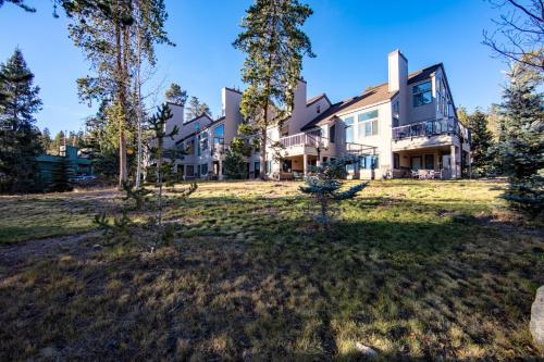 an exterior view of a large house with trees at Quicksilver #1602 in Keystone