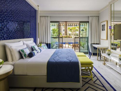 a bedroom with a large bed and a dining room at Rixos Premium Saadiyat Island - All Inclusive in Abu Dhabi